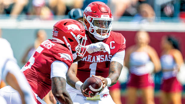 Razorbacks quarterback KJ Jefferson handing off to running back Raheim "Rocket" Sanders in 2023 season opener against Western Carolina in Little Rock.